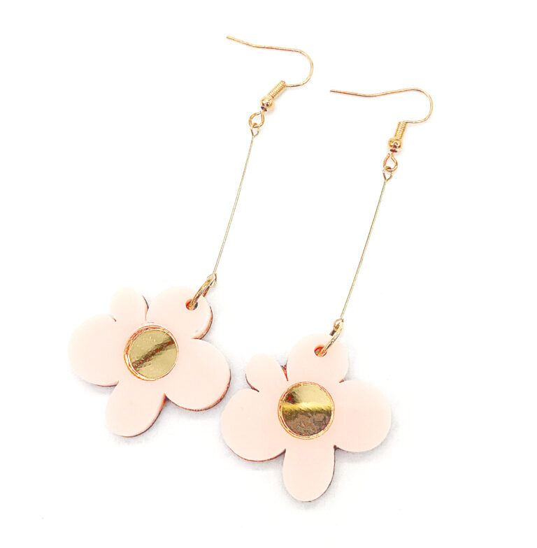 Photograph of pink daisy-shaped acrylic dangle earrings with gold mirror centres
